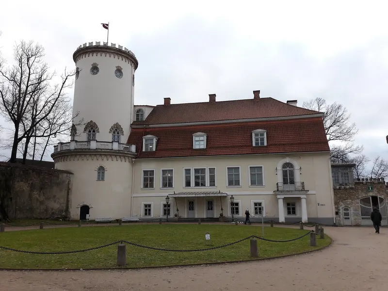 Front of Cēsis New Castle with its pale facade and round Lademaher Tower