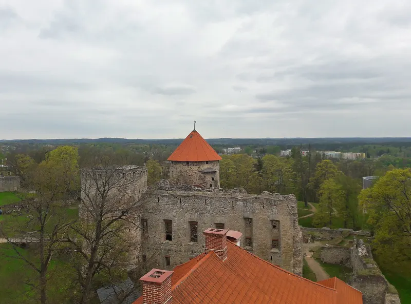Medieval castle walls and red-roofed tower viewed from Cēsis New Castle