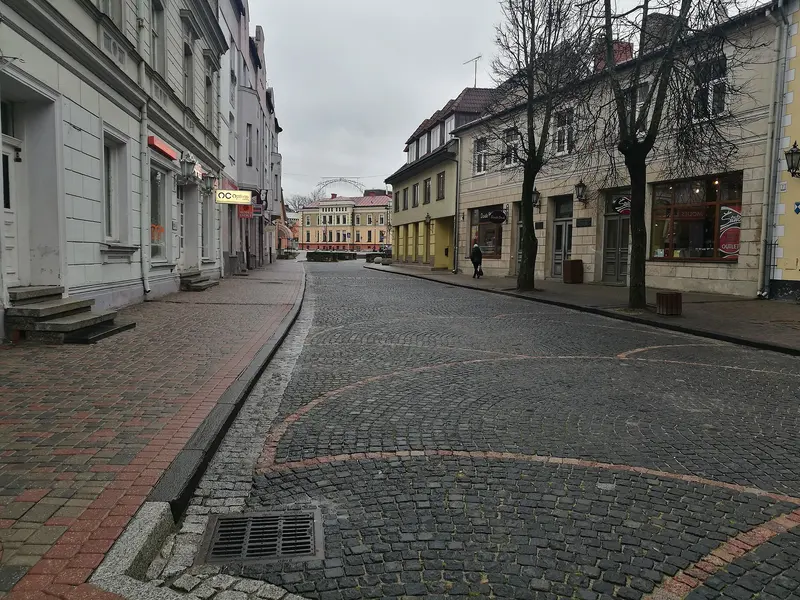 Cobbled Rīgas iela lined with shopfronts in Cēsis Old Town